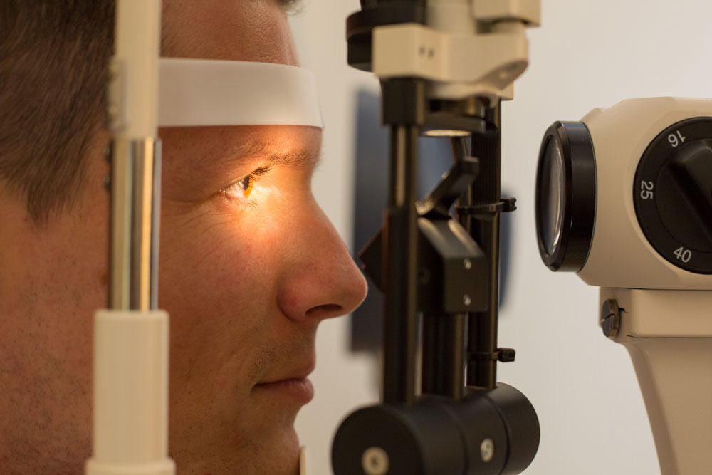 Patient at slit lamp of optician or optometrist